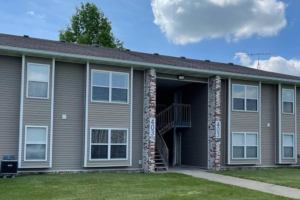 a brown house with a staircase in the garage at The Irene - 2 Bedroom Apt in Quilt Town, USA in Hamilton