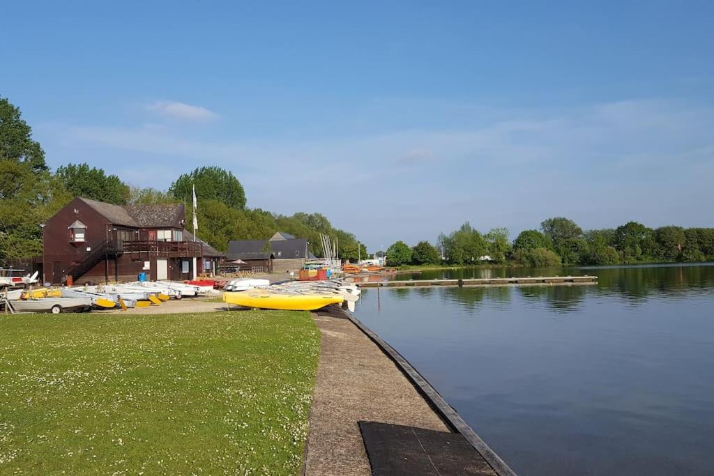 a group of boats are docked on a lake at Lovely Cosy Apartment near Water Parks in South Cerney