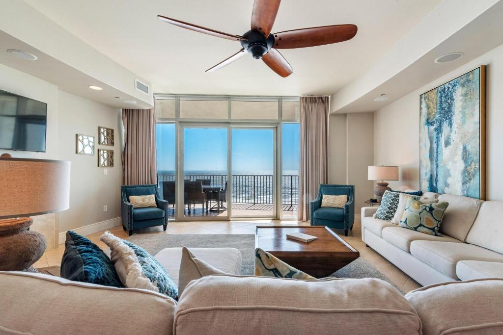 a living room with a couch and a ceiling fan at Turquoise C702 in Orange Beach