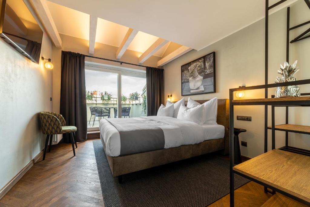 a hotel room with a bed and a window at The Viaduct - Suites & More in Prague