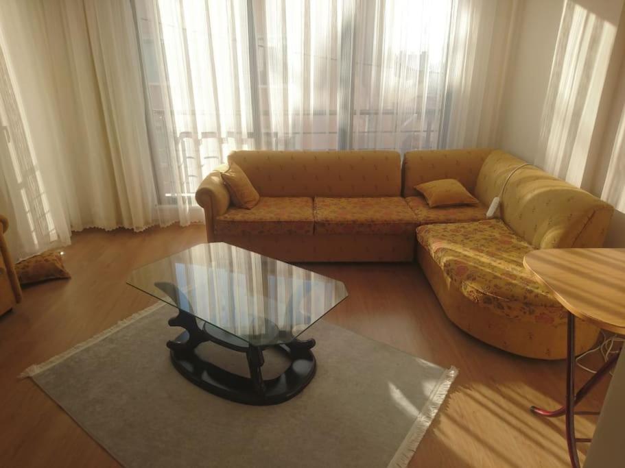 a living room with a couch and a glass table at COMFORT HOUSE in Istanbul