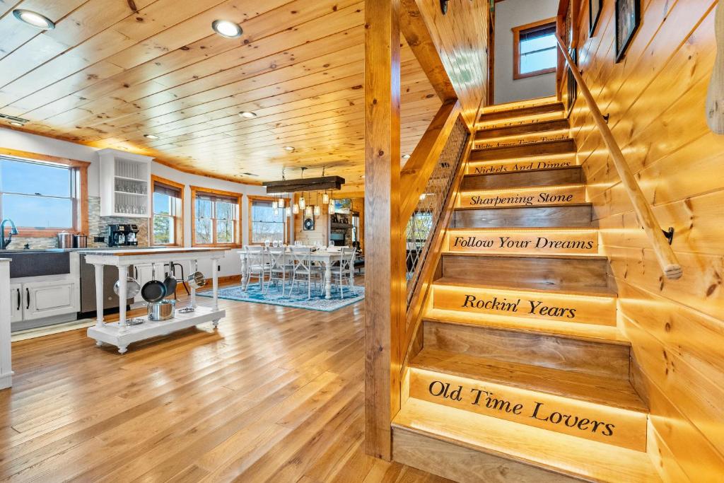 a staircase in a house with wooden ceilings at A Song Writers Paradise, Hot Tub Once Owned By Dolly Parton in Sevierville