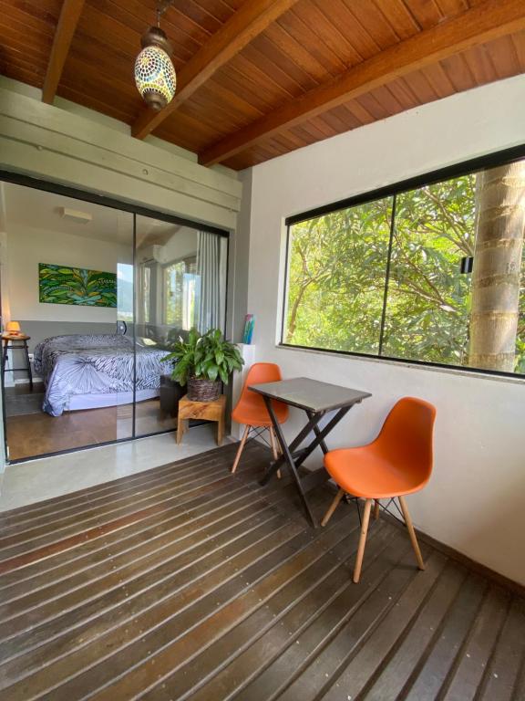 una habitación con mesa y sillas y un dormitorio en Guest room Casa SEA en Florianópolis