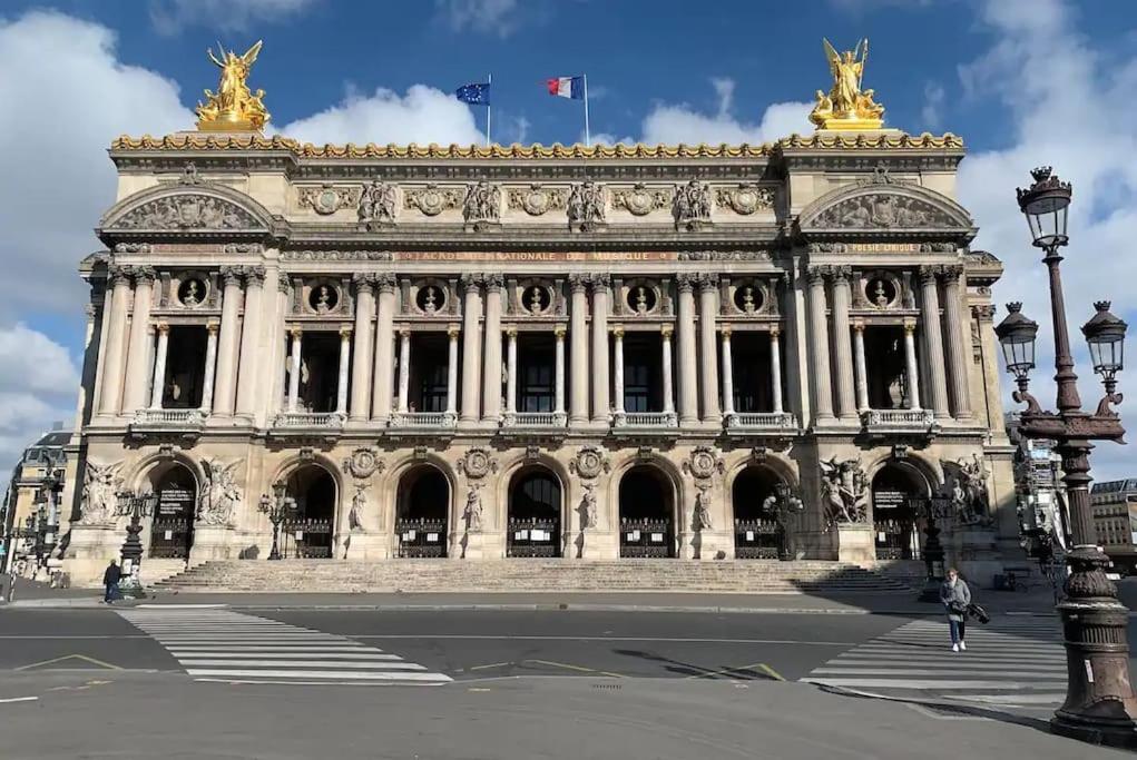 a large building with a flag on top of it at Cozy - Free Parking - 15mn from Paris Montparnasse in Clamart