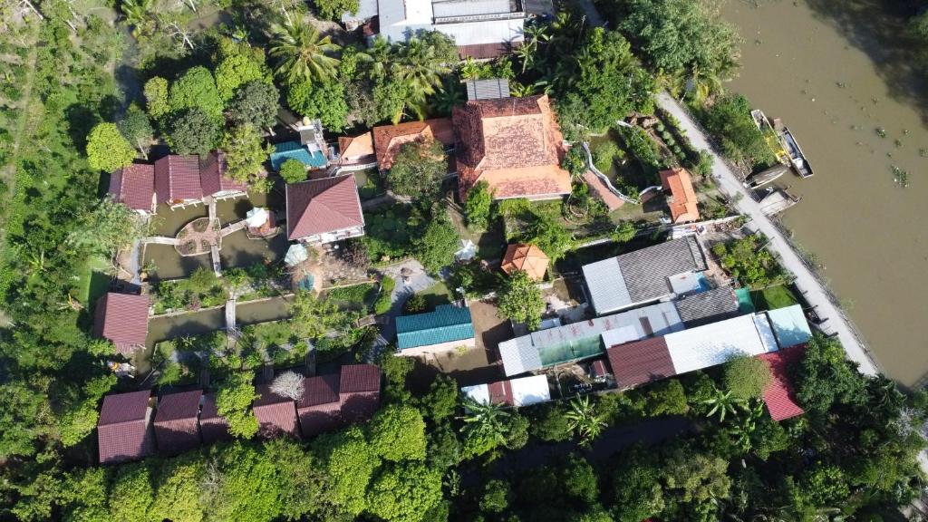 an overhead view of a group of houses in the forest at Brown House Resort in Can Tho