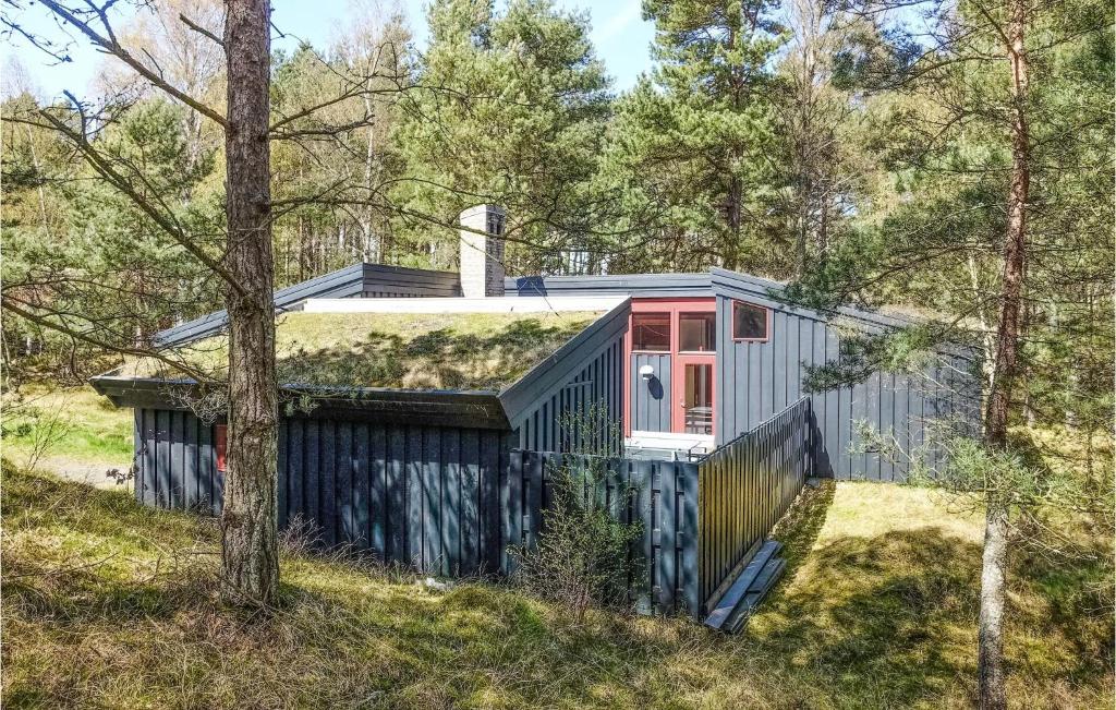 a tiny house with a grass roof in the woods at Gorgeous Home In Nex With Wifi in Vester Sømarken