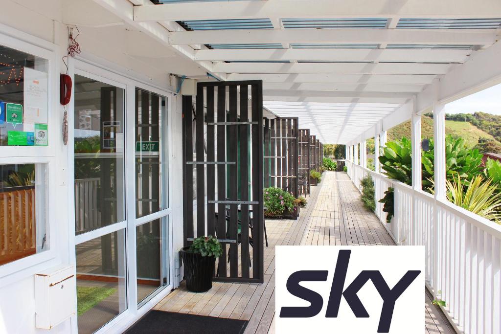 a white porch with a sign that says sky at Te Awa Motel in Whanganui