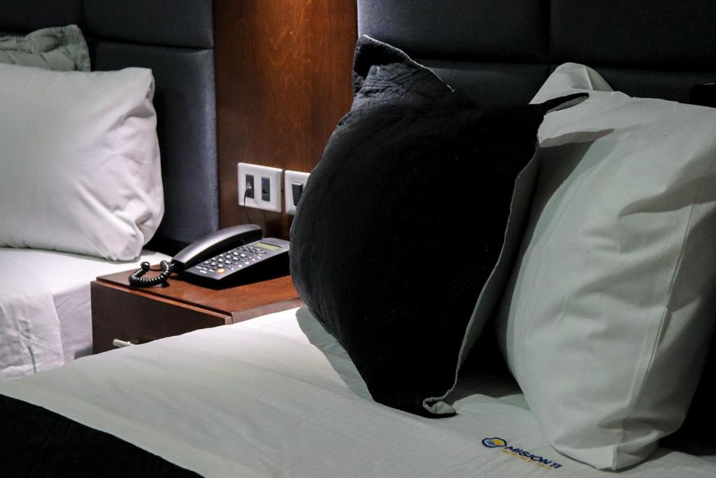 Postel nebo postele na pokoji v ubytování HOTEL MISION 11