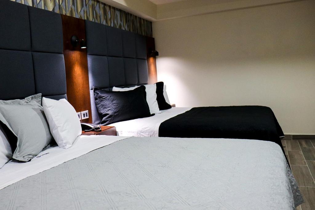 Postel nebo postele na pokoji v ubytování HOTEL MISION 11