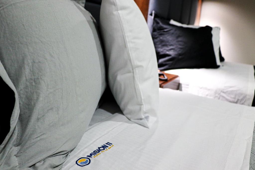 Postel nebo postele na pokoji v ubytování HOTEL MISION 11