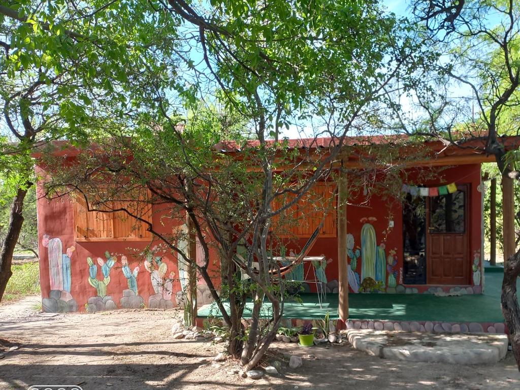 a house with a painting on the side of it at Jardin de Estrellas in San Marcos Sierras