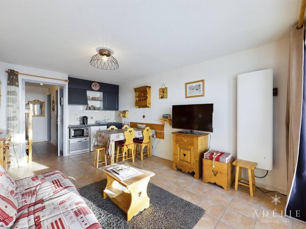 a living room with a table and a kitchen at Studio Montvalezan-La Rosière, 1 pièce, 4 personnes - FR-1-398-653 in Montvalezan