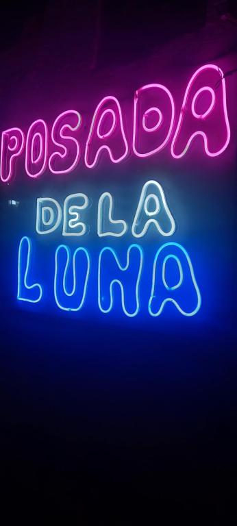 a neon sign that says passion be a liar at posada de la luna in Belén