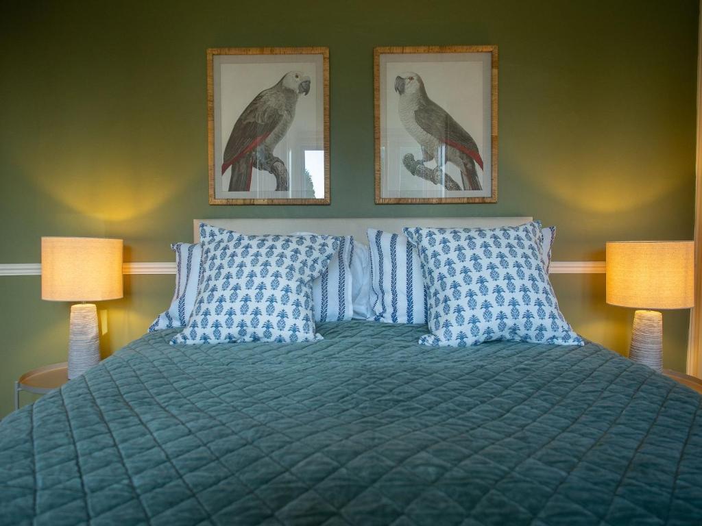 a bedroom with a bed with two pictures on the wall at The Beeches - Chatsworth Apartment No 1 - Sleeps 2 in Baslow