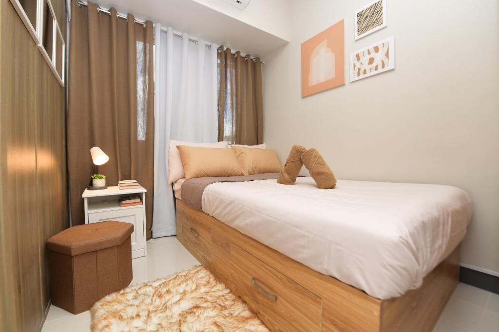 a bedroom with a bed with shoes on it at Condo in Pasay in Manila