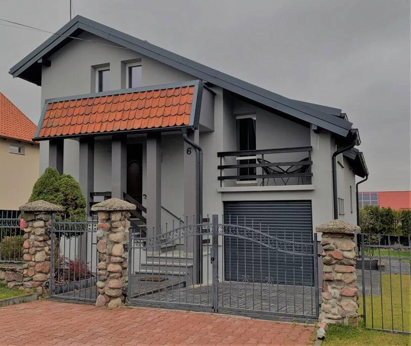 a house with a gate and a garage at Lapa House in Mrągowo