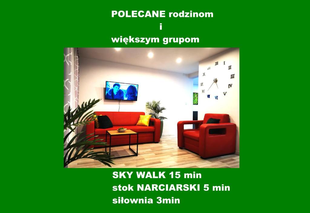een woonkamer met een rode bank en een stoel bij Chillout Apart 4You in Świeradów-Zdrój