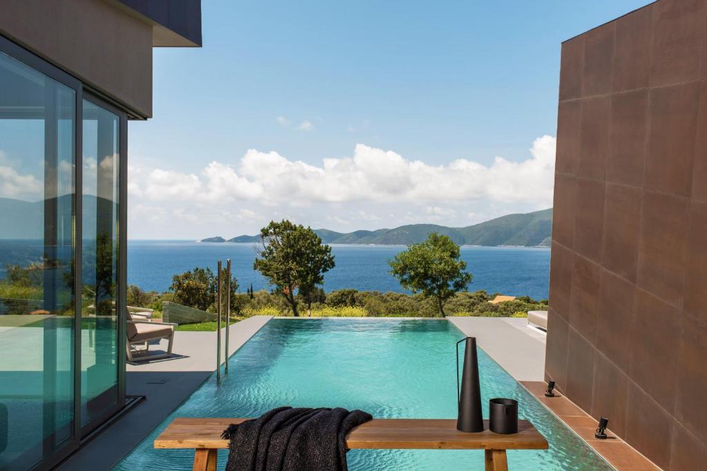 a pool with a view of the ocean from a house at Gaia and Thalatta Villas in Évyiros