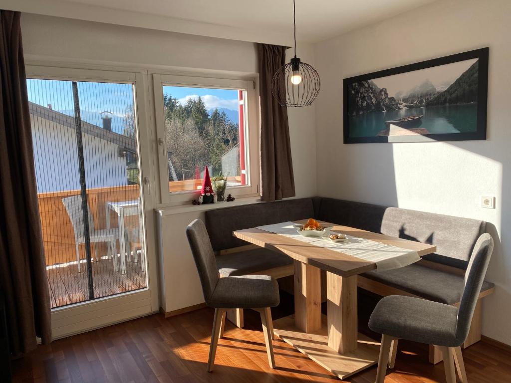 a dining room with a table and chairs and a window at Wohnung Steixner in Westendorf