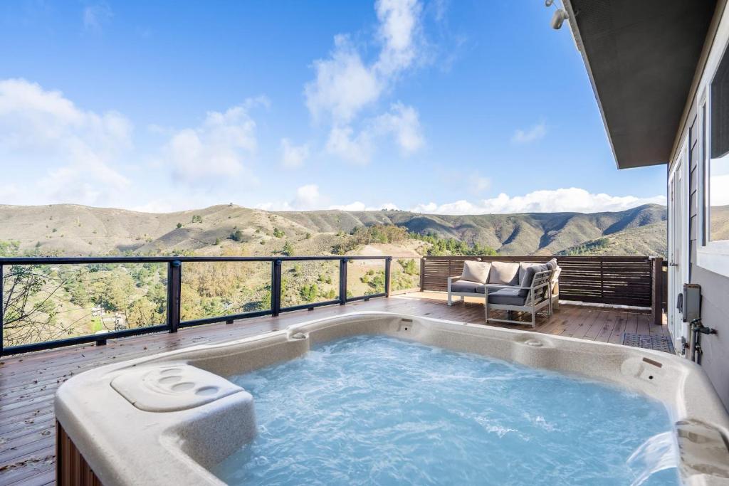a hot tub on a balcony with a view of the mountains at @ Marbella Lane - Hidden Gem in Pacifica! in Pacifica