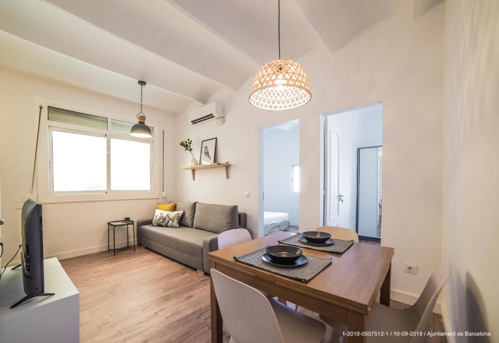 a living room with a dining room table and a couch at Poblenou 3bd 5 min to the Beach in Barcelona