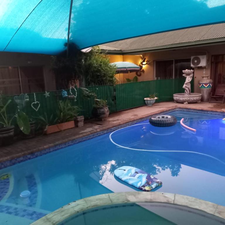 a swimming pool with a toy car in the middle at Schweizer Guesthouse in Schweizer-Reineke