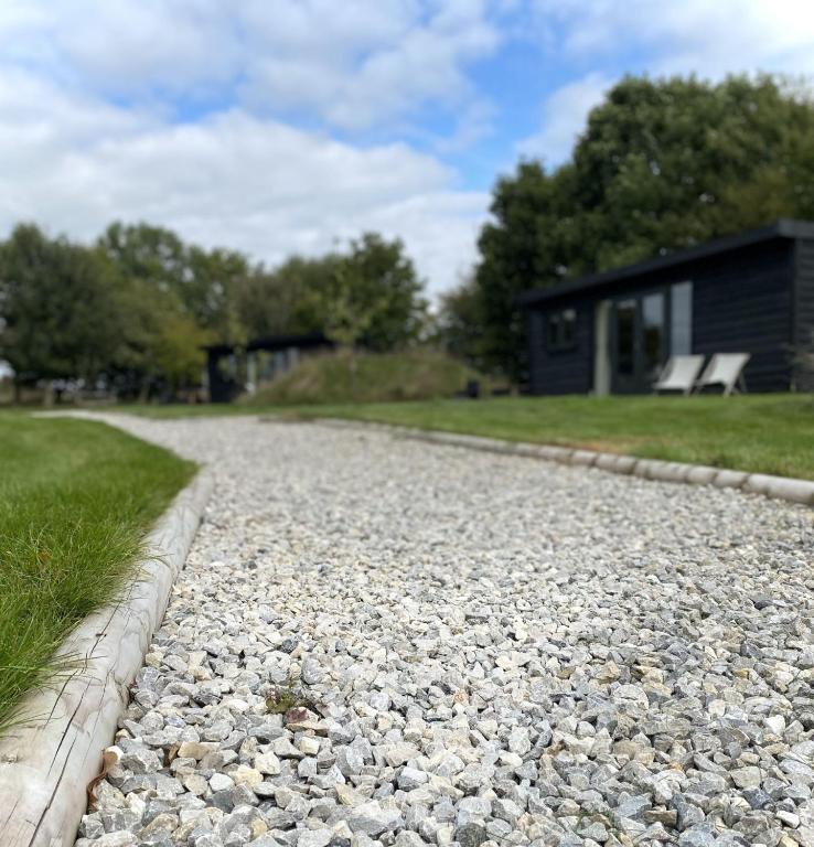 a gravel road in front of a house at Meadow View - Bottom Cabin in Foolow