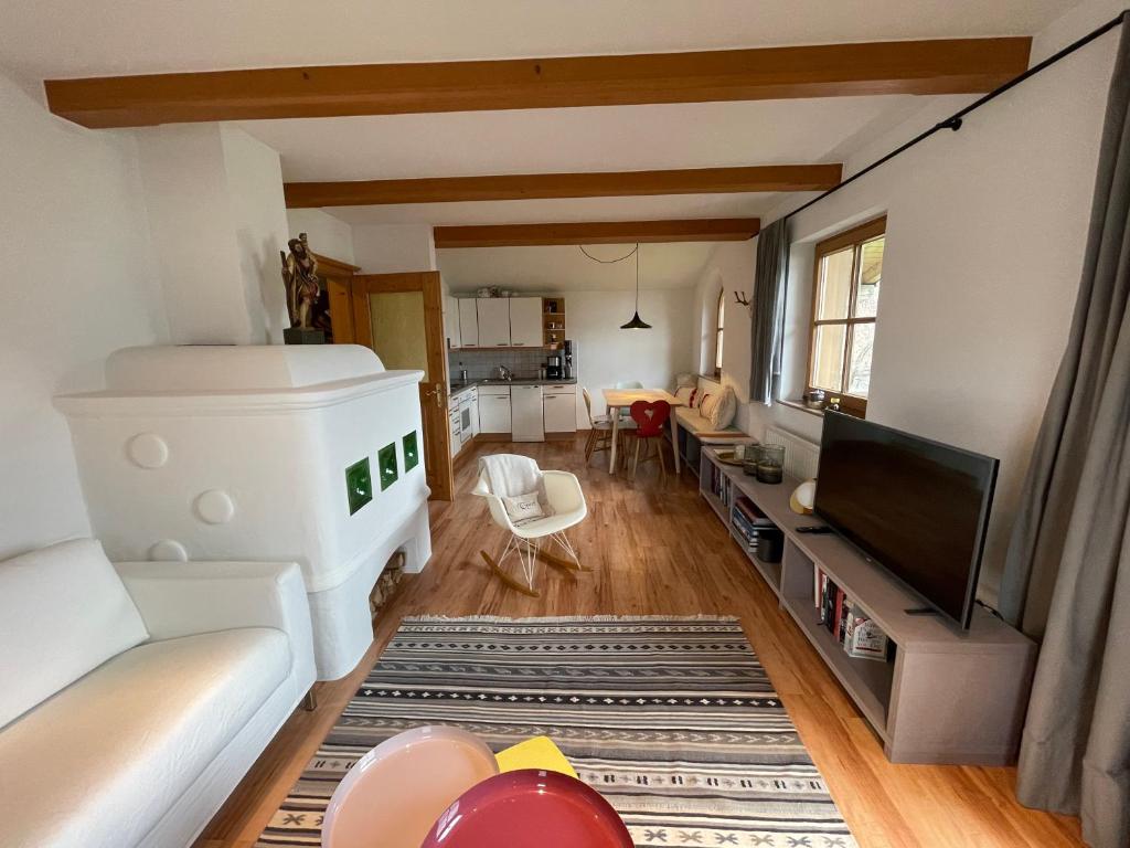 Design Apartment Westendorf by Alpine Host Helpers في وستندورف: غرفة معيشة مع أريكة وتلفزيون