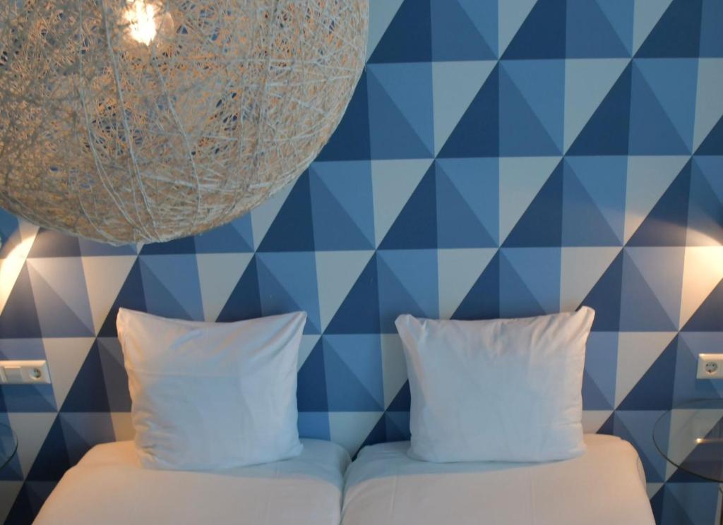 Een bed of bedden in een kamer bij Hotel Steeds aan Zee