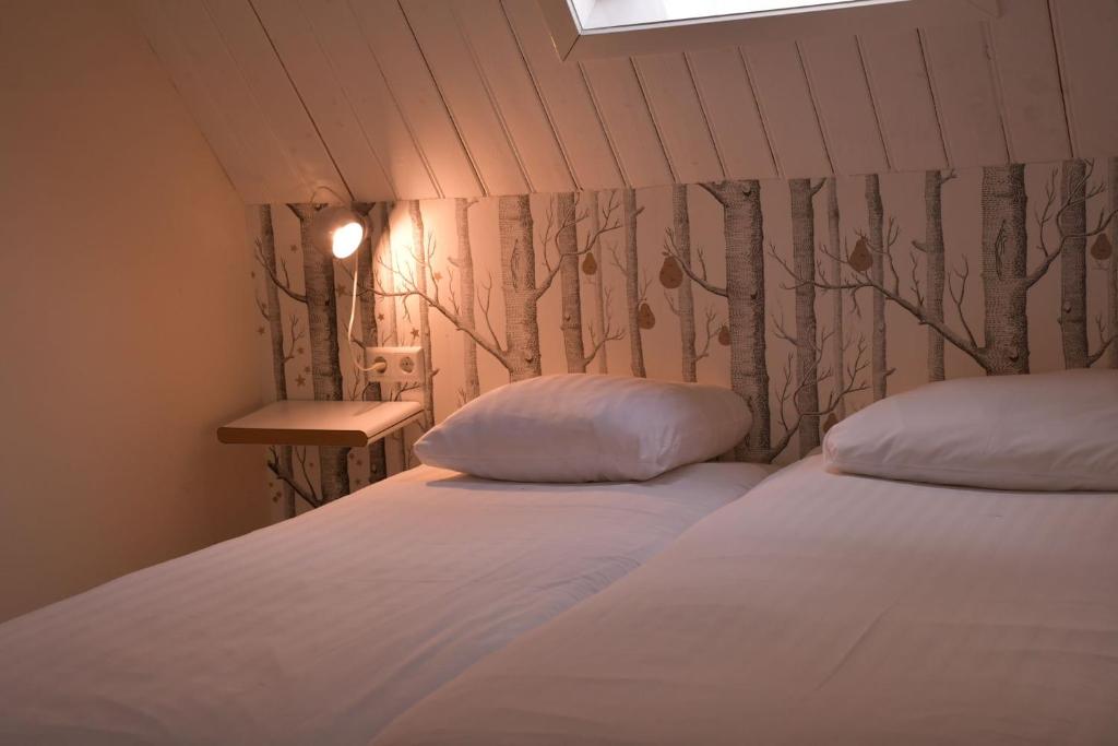 Een bed of bedden in een kamer bij Hotel Steeds aan Zee