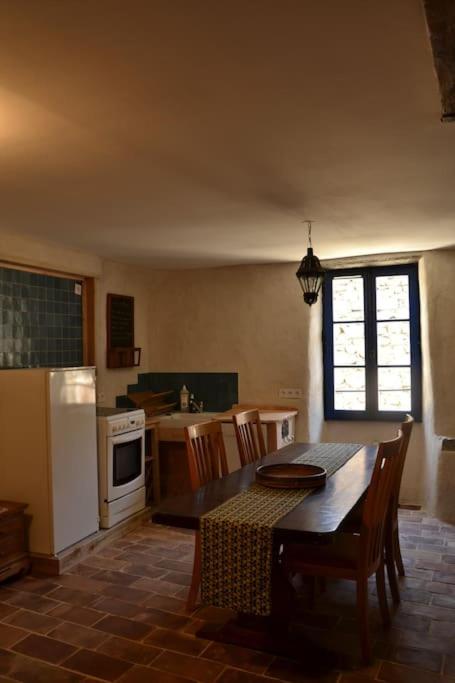 kuchnia ze stołem i krzesłami oraz kuchnia z kuchenką w obiekcie Gîte 'An Kay Ou' - L'Aiglette w mieście Pontaix