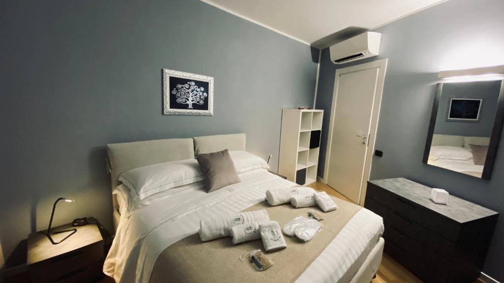 a bedroom with a bed with two remotes on it at Le Chicche del Porto - Allure in Genoa