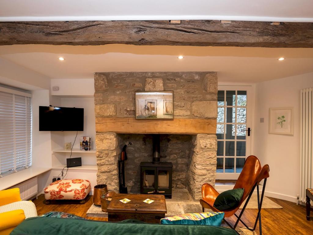 a living room with a stone fireplace at A Hidden Gem in the Heart of Wells, Somerset in Wells