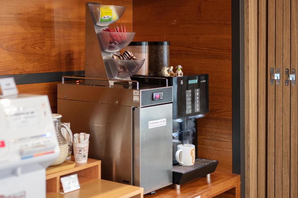 a kitchen with a refrigerator and a coffee maker at Chaiin Hotel - Dongmen in Taipei