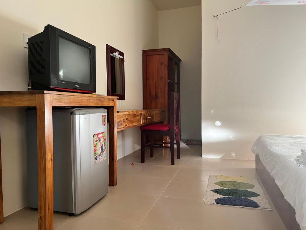 TV a/nebo společenská místnost v ubytování The Palm Tree Guesthouse