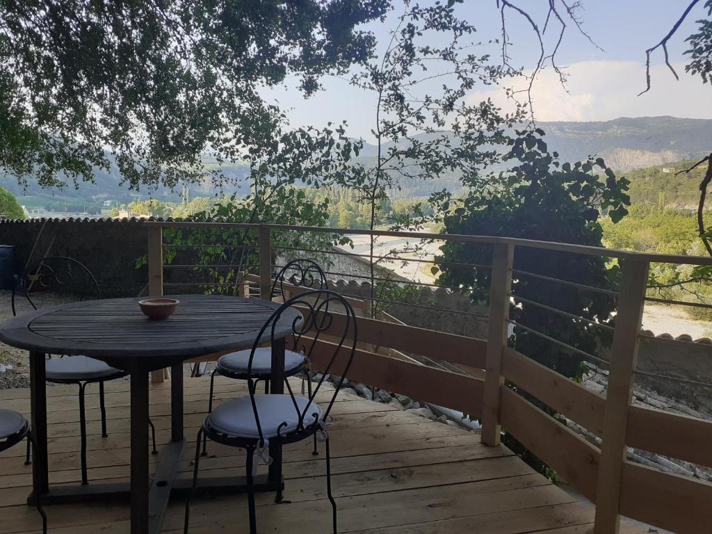 a table and chairs on a deck with a view at Gîte &#39;An Kay Ou&#39; - Le Grand Barry in Pontaix