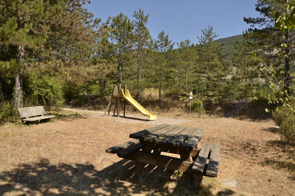 a playground with a bench and a slide at Gîte &#39;An Kay Ou&#39; - Le Grand Barry in Pontaix