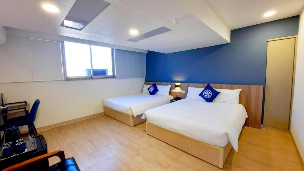 Postel nebo postele na pokoji v ubytování Holo Hotel Tainan