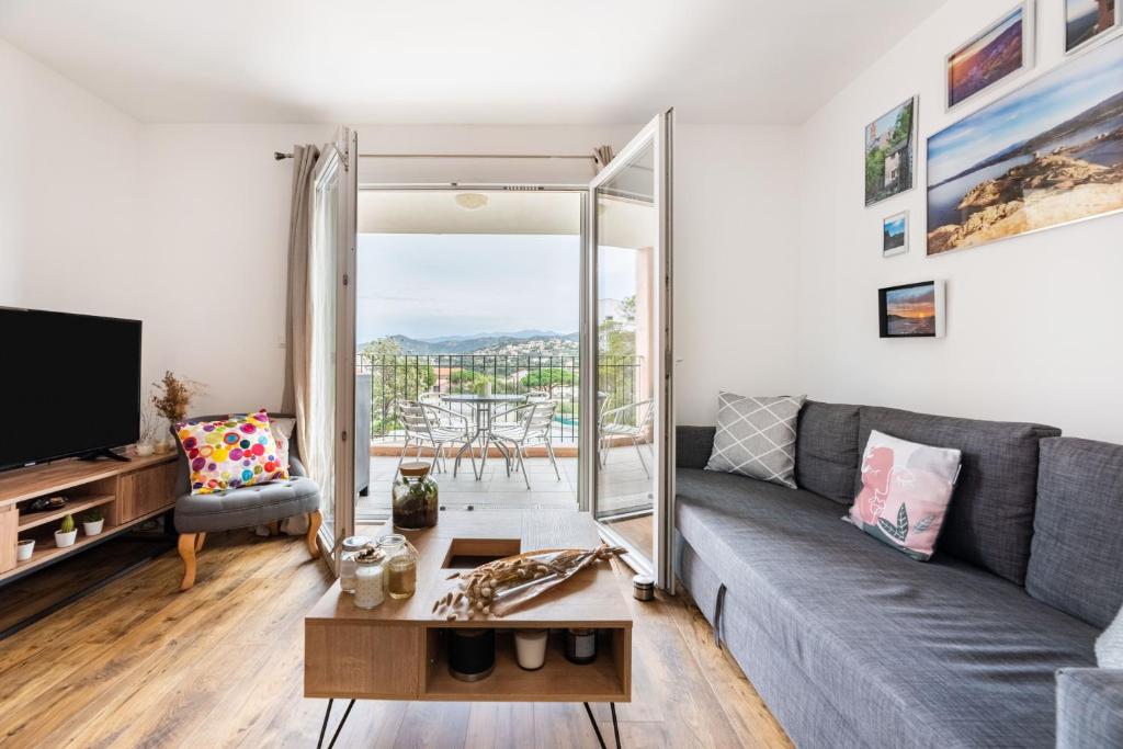 un soggiorno con un divano e una TV di Occi a LʼÎle-Rousse