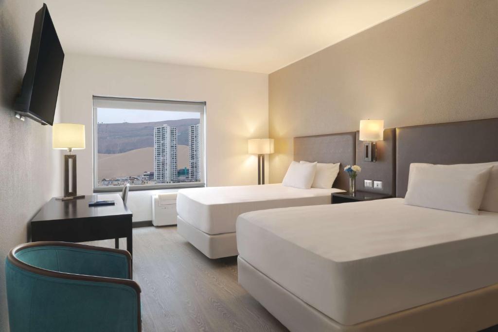Una cama o camas en una habitación de NH Iquique Costa