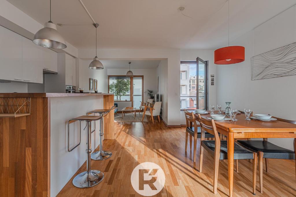 une cuisine et une salle à manger avec une table et des chaises dans l'établissement R'Apparts T3 L'Idéal Caserne De Bonne, à Grenoble