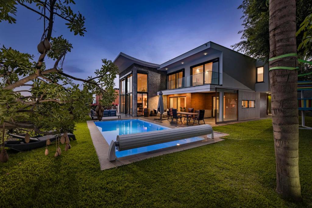 a house with a swimming pool in the yard at Villa das Quebradas by An Island Apart in Funchal