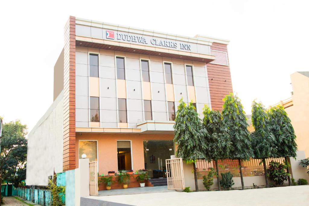 a building with a sign on the front of it at Clarks Inn Dudhwa in Paliā Kalān