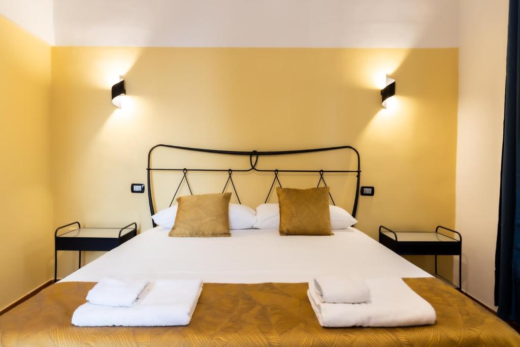 a bedroom with a large bed with two pillows at Sebeto Duomo in Naples