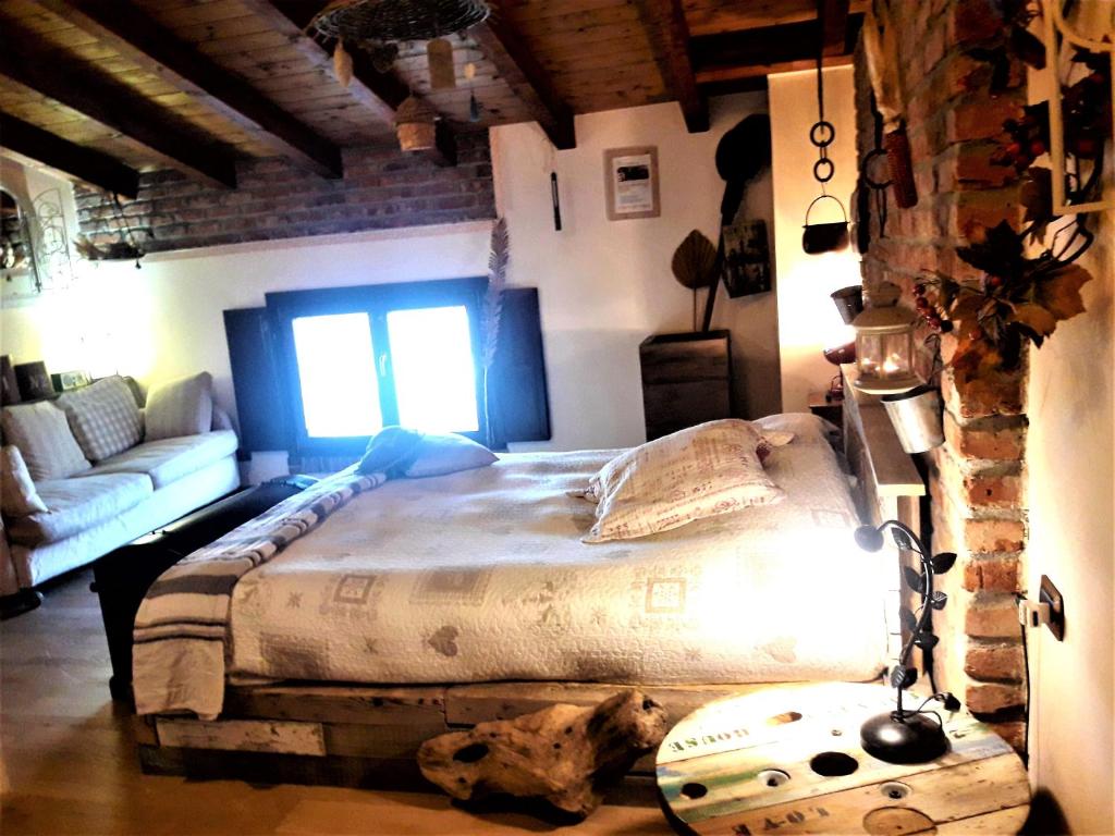 Postel nebo postele na pokoji v ubytování B&B Relais Cascina al Campaccio