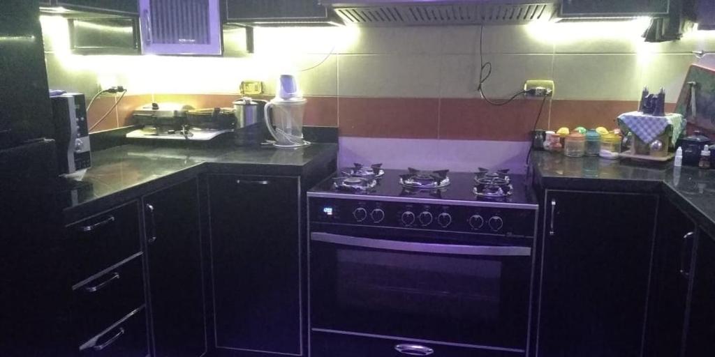 a kitchen with a black stove top oven at اطلاله مباشره عالنيل in Kafr Abū Dabbūs
