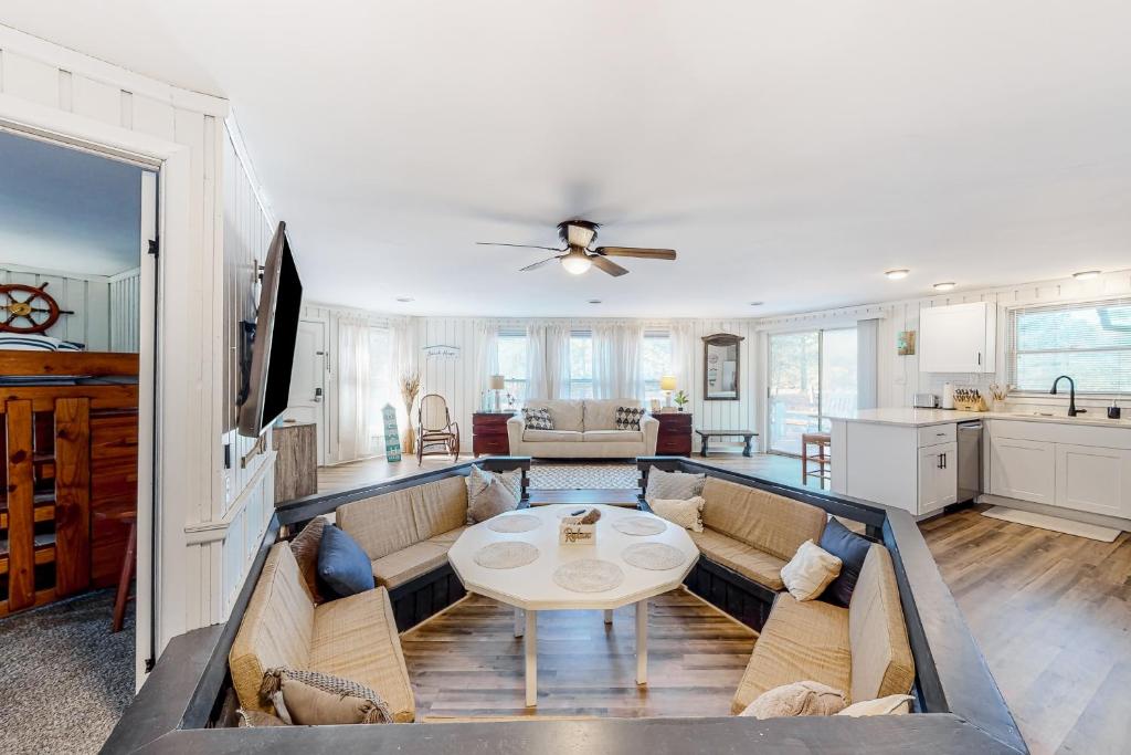 uma sala de estar com um sofá e uma mesa em Beach House em Kill Devil Hills
