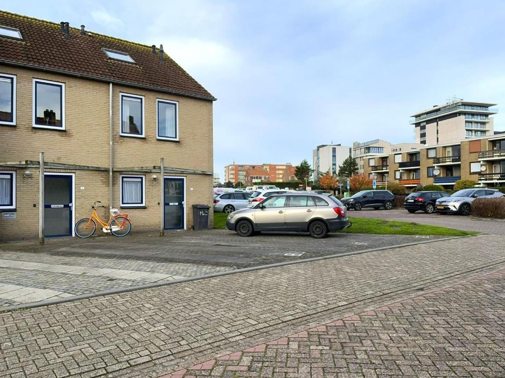 a car parked in a parking lot next to a building at Meidoornstraat 2 parterre in Cadzand