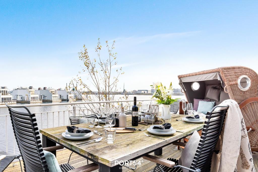 a table on a deck with a view of the water at Harbour House in Olpenitz