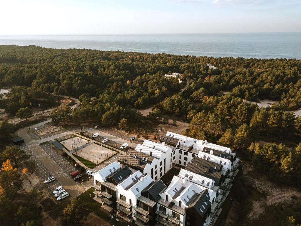 an aerial view of a building with the ocean in the background at ApartView Porto Łeba by Rent like home in Łeba